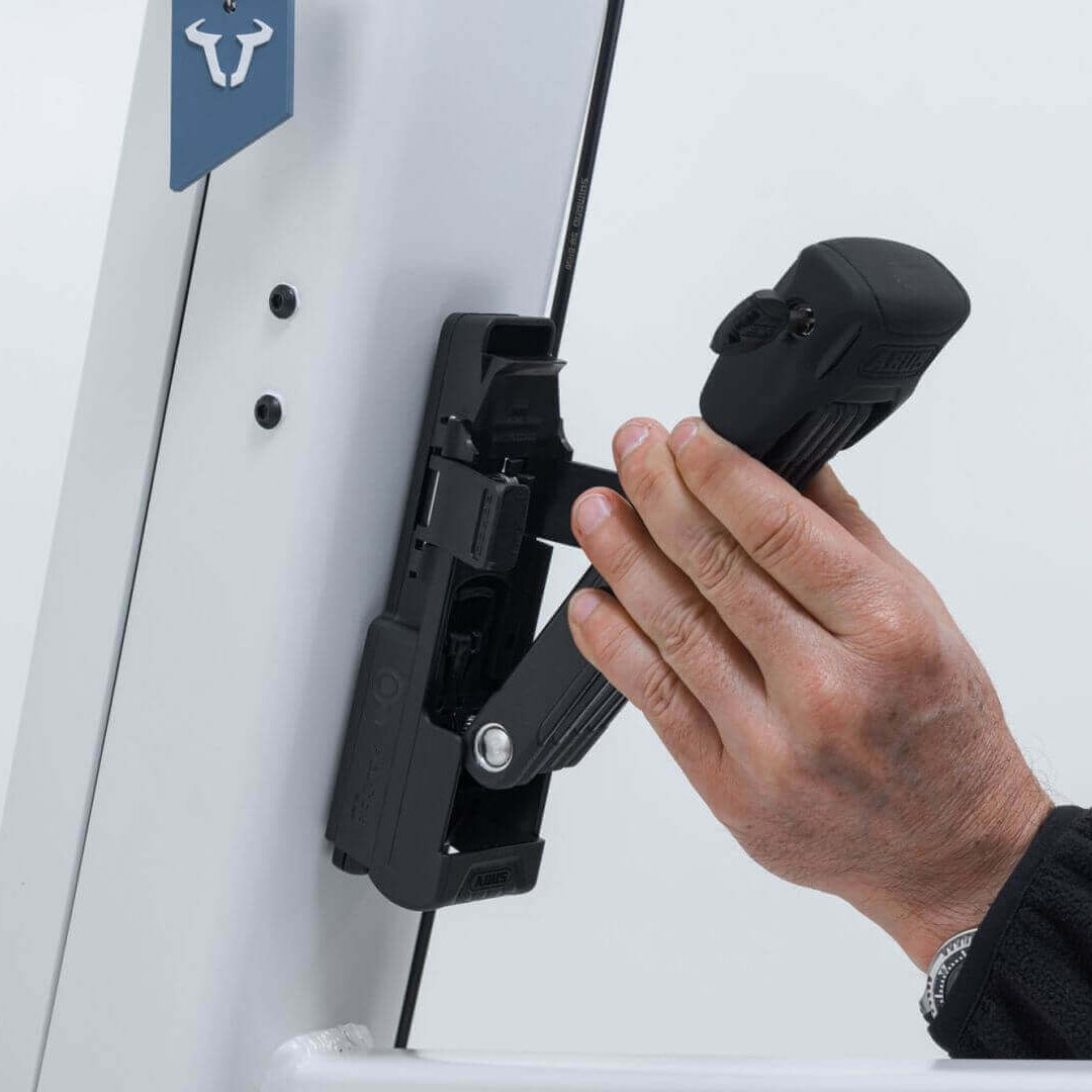 Person using the ABUS Bordo 6000K Faltschloss with Fidlock system for secure attachment.